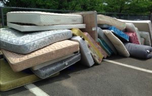 Piles of old mattresses for bulk pickup