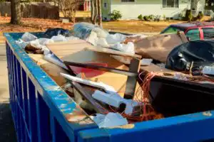 Trash getting collected in a bulk pick up garbage container