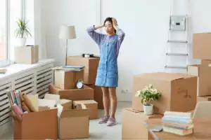 Woman overwhelmed by the boxes of junk in her living room