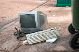 Discarded old desktop computer and keyboard on the side of the street